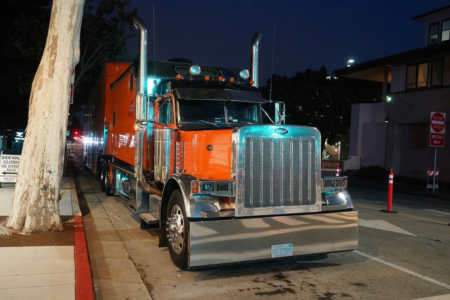 A tractor unit parked under lights at night
